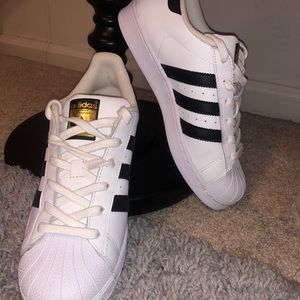 white and black adidas sneakers.
